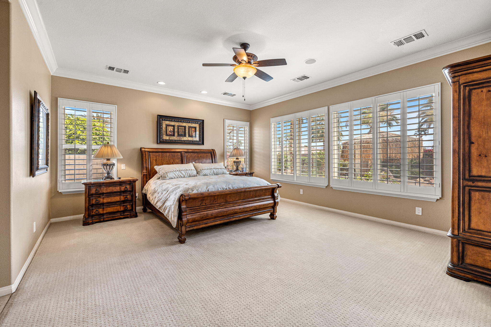49722 Jordan Street Indio, CA 92201 - Photo 13 of 38 a spacious bedroom with a bed and a large window