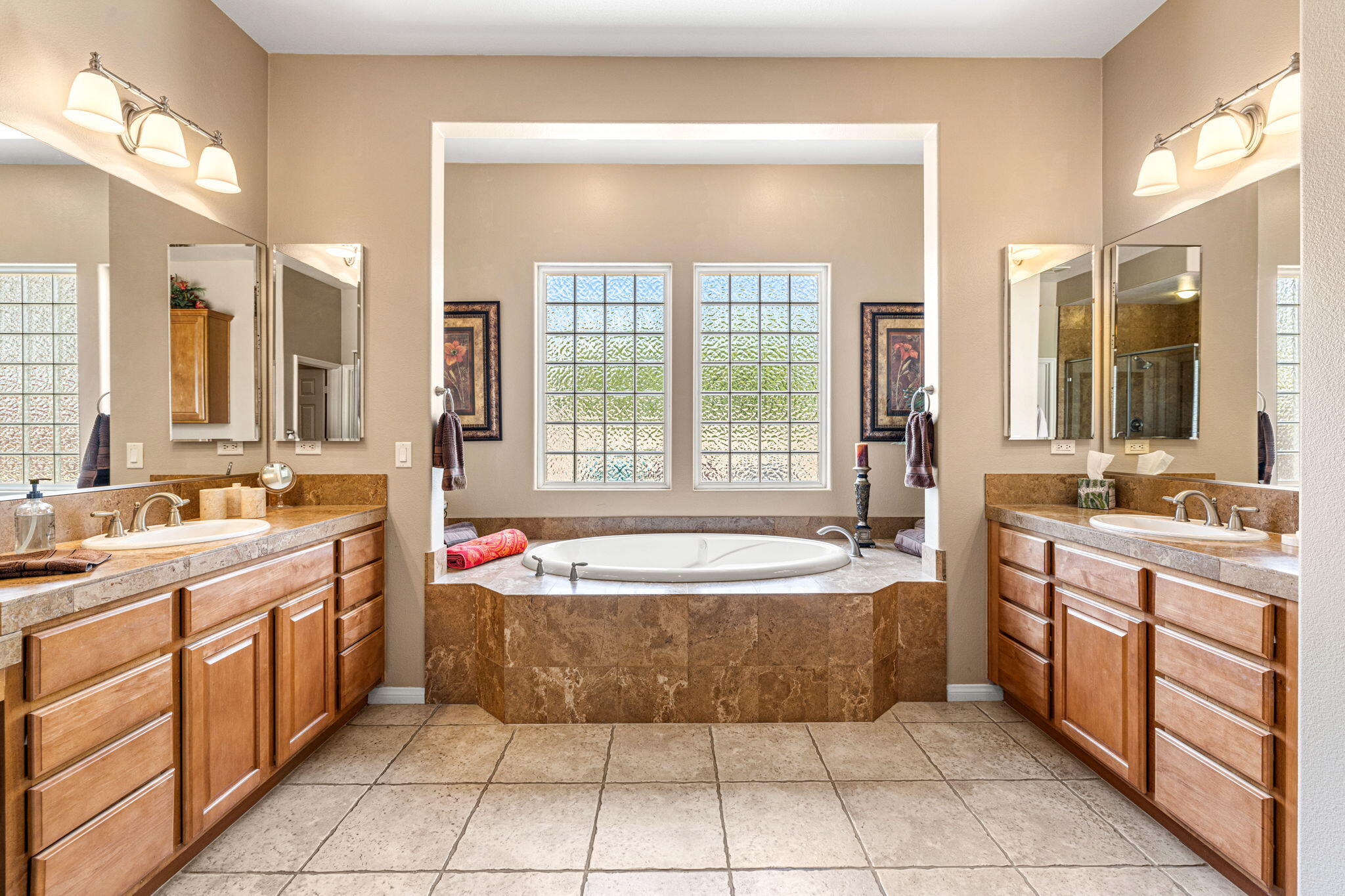 49722 Jordan Street Indio, CA 92201 - Photo 14 of 38 a spacious bathroom with a tub sink and mirror