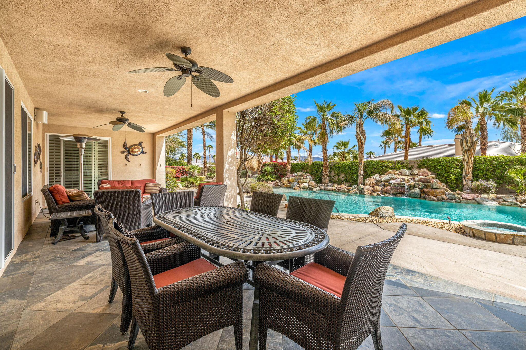 49722 Jordan Street Indio, CA 92201 - Photo 21 of 38 a view of a patio with a dining table and chairs with a patio