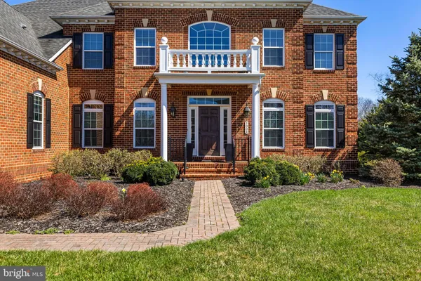 a front view of a house with garden and porch