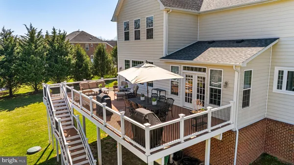 a roof deck with table and chairs under an umbrella