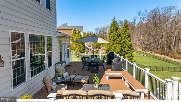 a view of a patio with couches table and chairs and potted plants