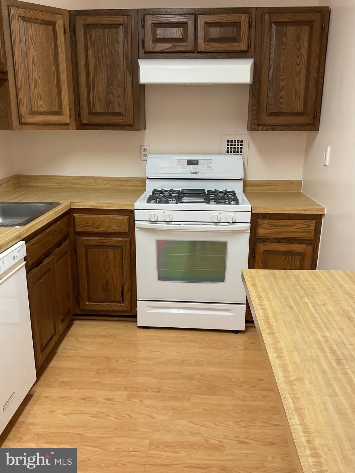 2939 Van Ness Street Northwest, Unit 731 Washington, DC 20008 - Photo 11 of 14 a kitchen with stainless steel appliances granite countertop a stove top oven microwave and cabinets