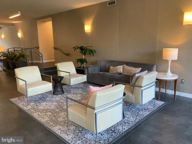 a living room with furniture and a lamp