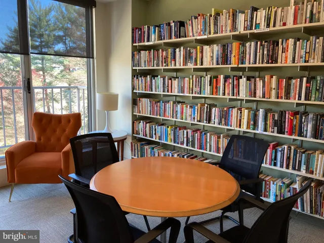 a view of a livingroom with furniture and a bookshelf