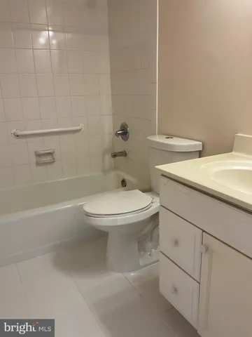 a white toilet sitting next to a bath tub