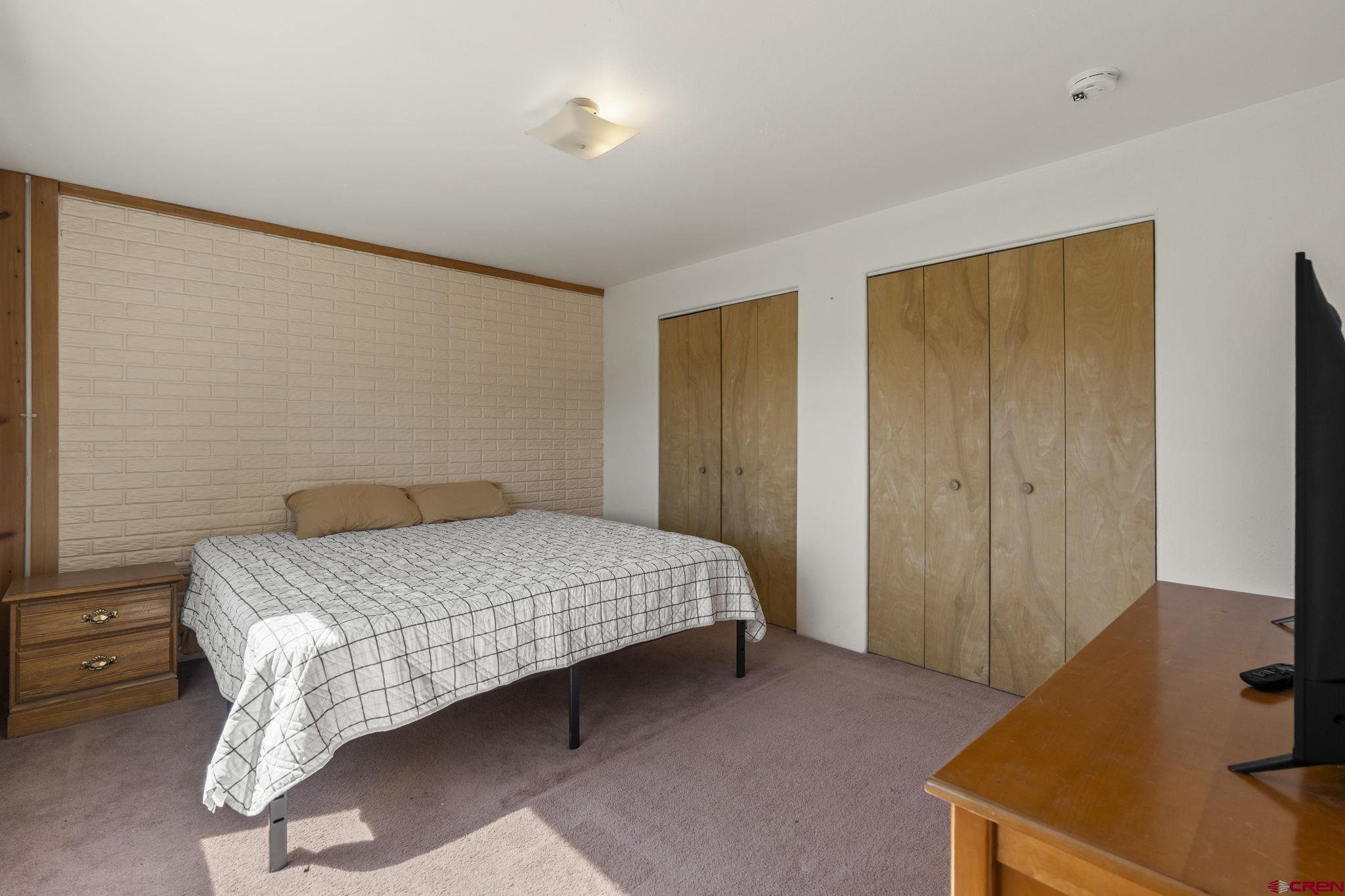 720 Sawmill Road Durango, CO 81303 - Photo 28 of 41 a bedroom with a bed and a dresser in it