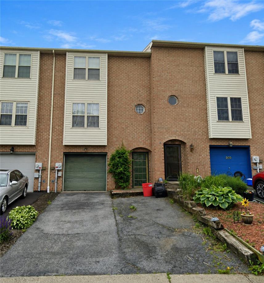 302 Ridgeview Drive Alburtis, PA 18011 - Photo 1 of 3 Brick facade townhouse with attached garages and modest landscaping.