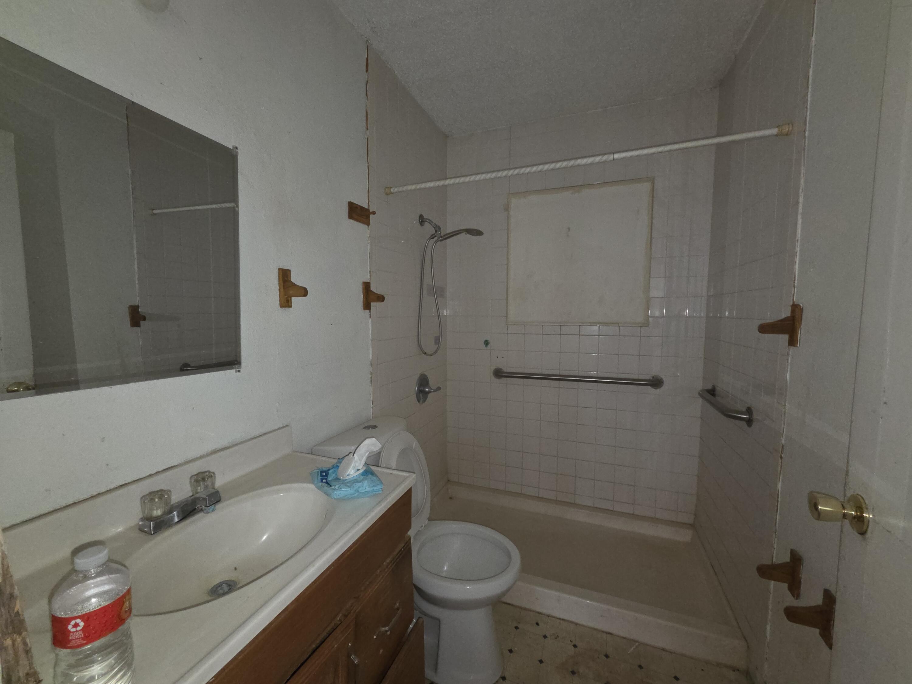 607 Zenith Avenue Lubbock, TX 79403 - Photo 5 of 8 a bathroom with a sink toilet vanity and shower