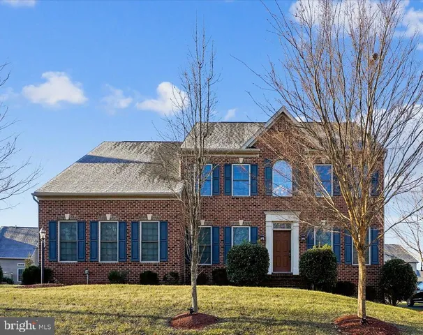 a view of a brick house with a yard