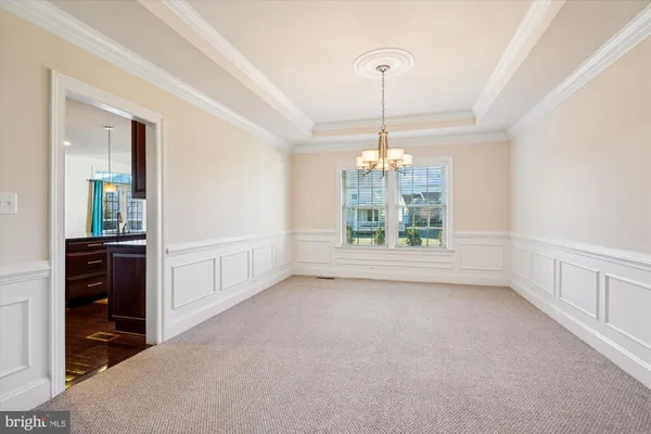 a view of an empty room with window and cabinet