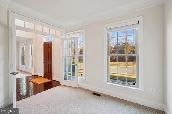 a living room with furniture and large windows