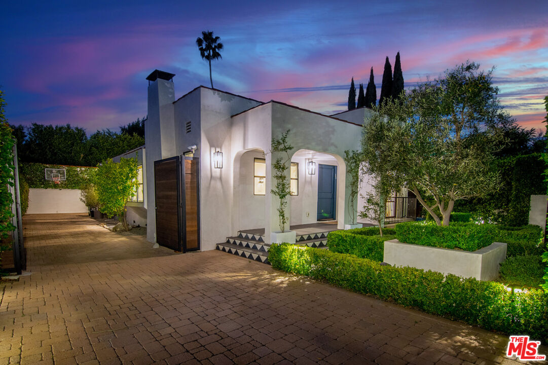 743 North June Street Los Angeles, CA 90038 - Photo 1 of 38 a front view of a house with a yard and garage