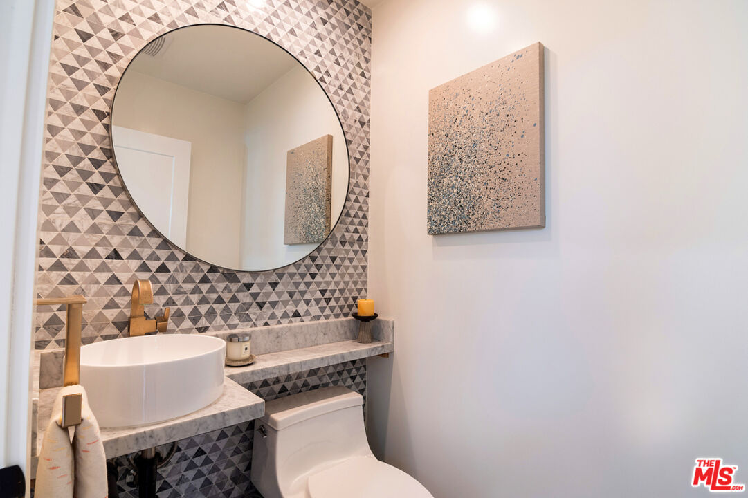 743 North June Street Los Angeles, CA 90038 - Photo 19 of 38 a bathroom with a toilet a sink and a mirror