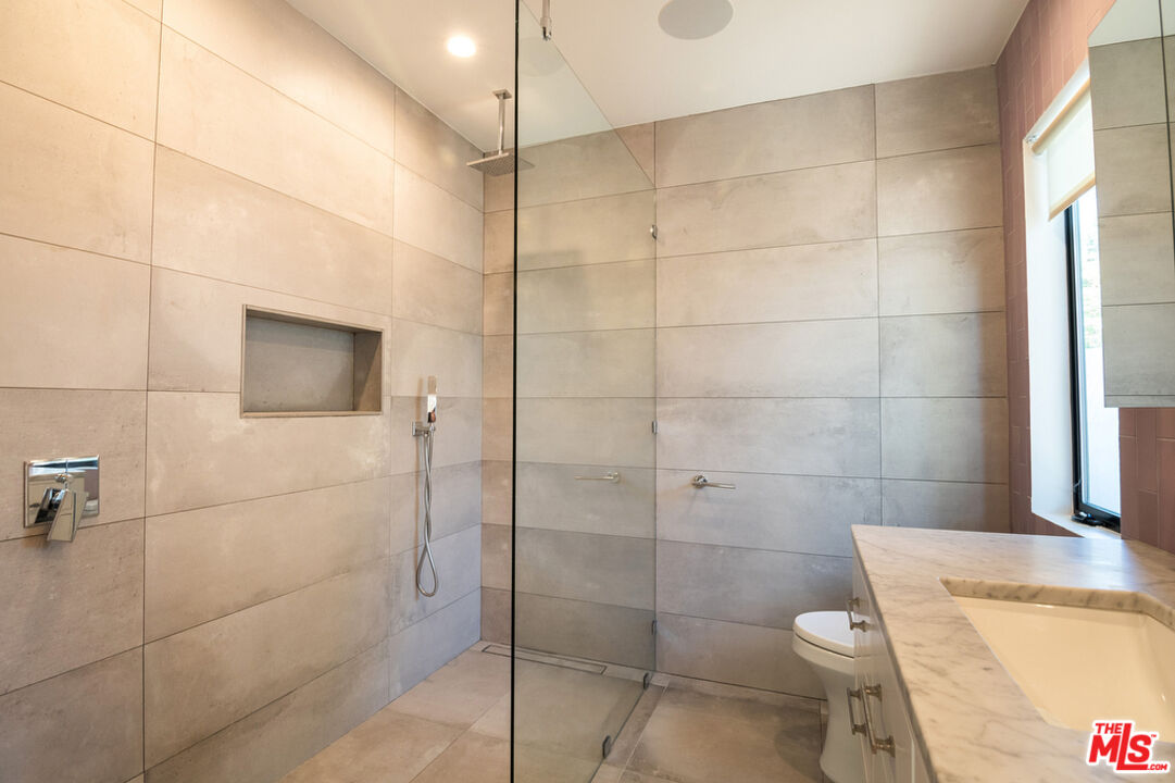 743 North June Street Los Angeles, CA 90038 - Photo 26 of 38 a bathroom with a shower a toilet and sink