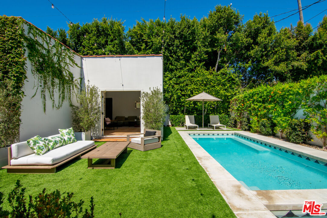 743 North June Street Los Angeles, CA 90038 - Photo 29 of 38 a view of a house with a backyard patio and a yard