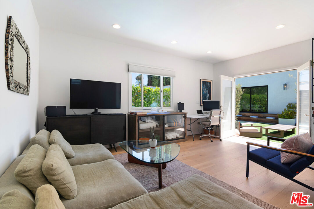 743 North June Street Los Angeles, CA 90038 - Photo 37 of 38 a living room with furniture and a flat screen tv