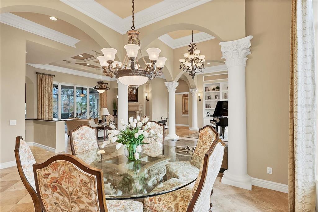 7007 Portmarnock Place Lakewood Ranch, FL 34202 - Photo 18 of 92 a view of a dining room with furniture and a chandelier