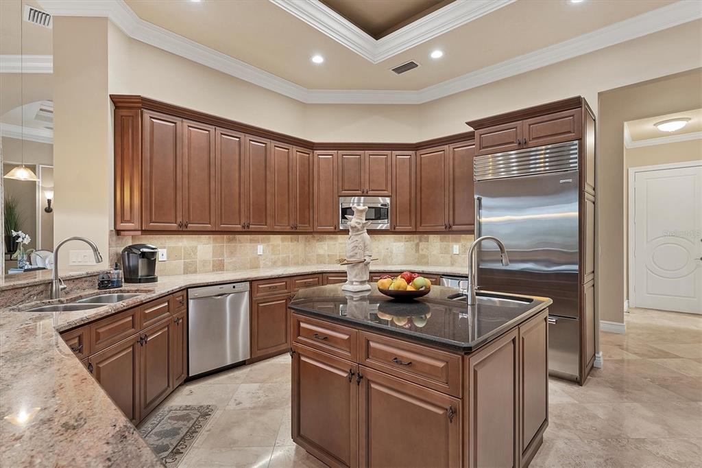 7007 Portmarnock Place Lakewood Ranch, FL 34202 - Photo 23 of 92 a kitchen with stainless steel appliances granite countertop a sink stove and refrigerator