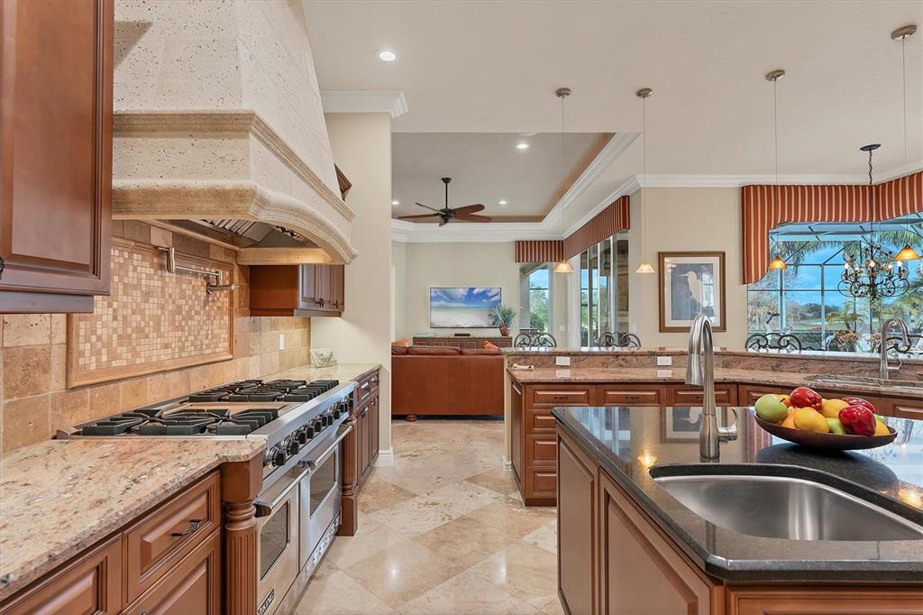7007 Portmarnock Place Lakewood Ranch, FL 34202 - Photo 24 of 92 a kitchen with stainless steel appliances granite countertop a sink stove and refrigerator