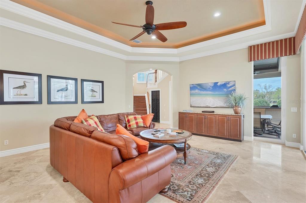 7007 Portmarnock Place Lakewood Ranch, FL 34202 - Photo 30 of 92 a living room with furniture and a flat screen tv