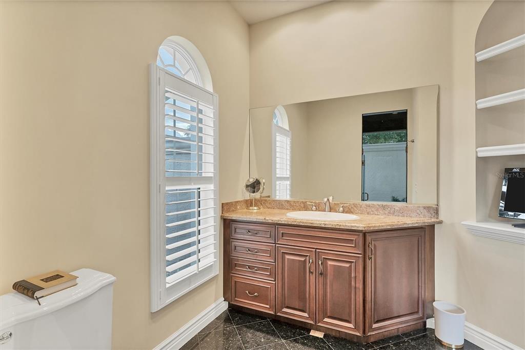 7007 Portmarnock Place Lakewood Ranch, FL 34202 - Photo 42 of 92 a bathroom with a granite countertop sink and a mirror