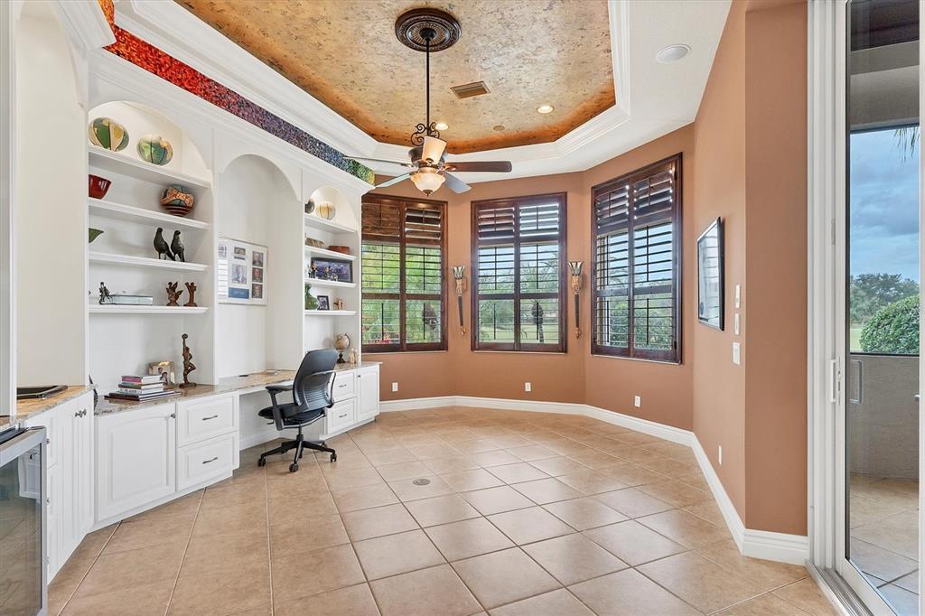 7007 Portmarnock Place Lakewood Ranch, FL 34202 - Photo 44 of 92 a view of workspace with a window and gym equipment