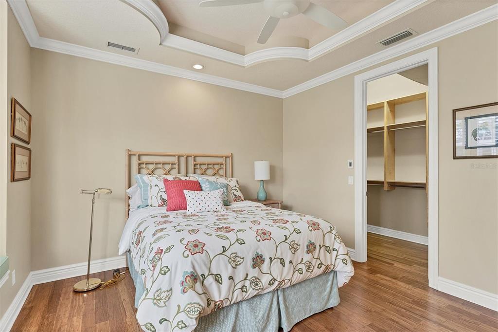 7007 Portmarnock Place Lakewood Ranch, FL 34202 - Photo 47 of 92 a bedroom with a bed and wooden floor