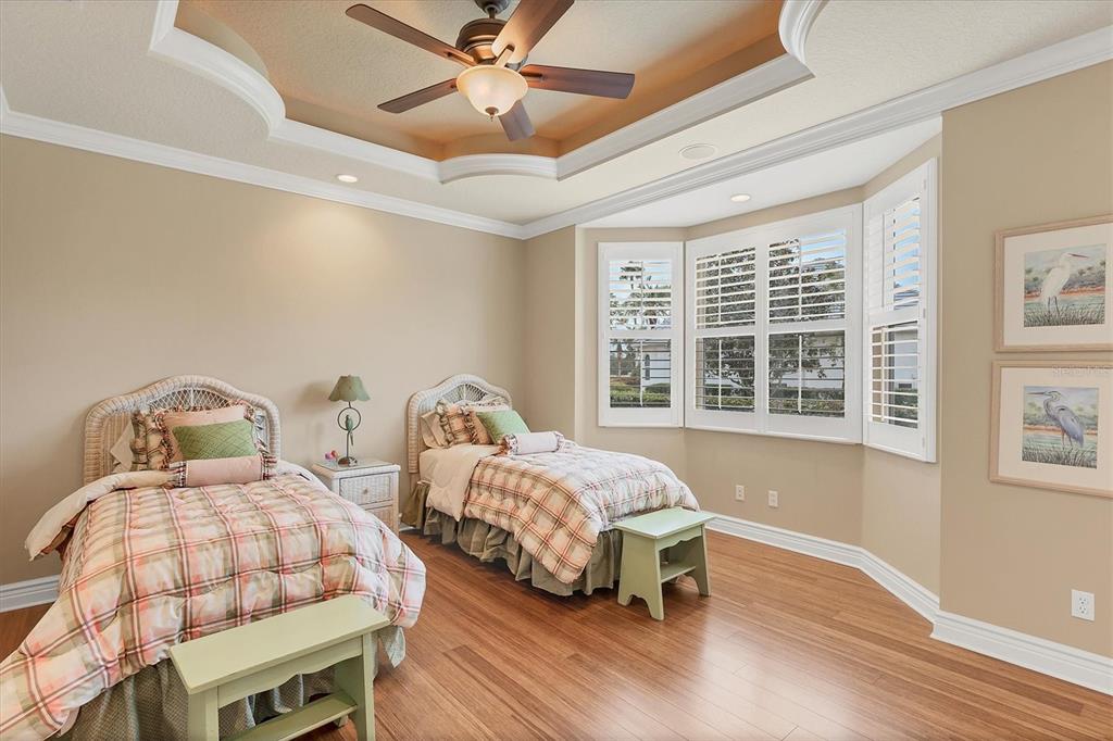 7007 Portmarnock Place Lakewood Ranch, FL 34202 - Photo 50 of 92 a bedroom with two beds and a window
