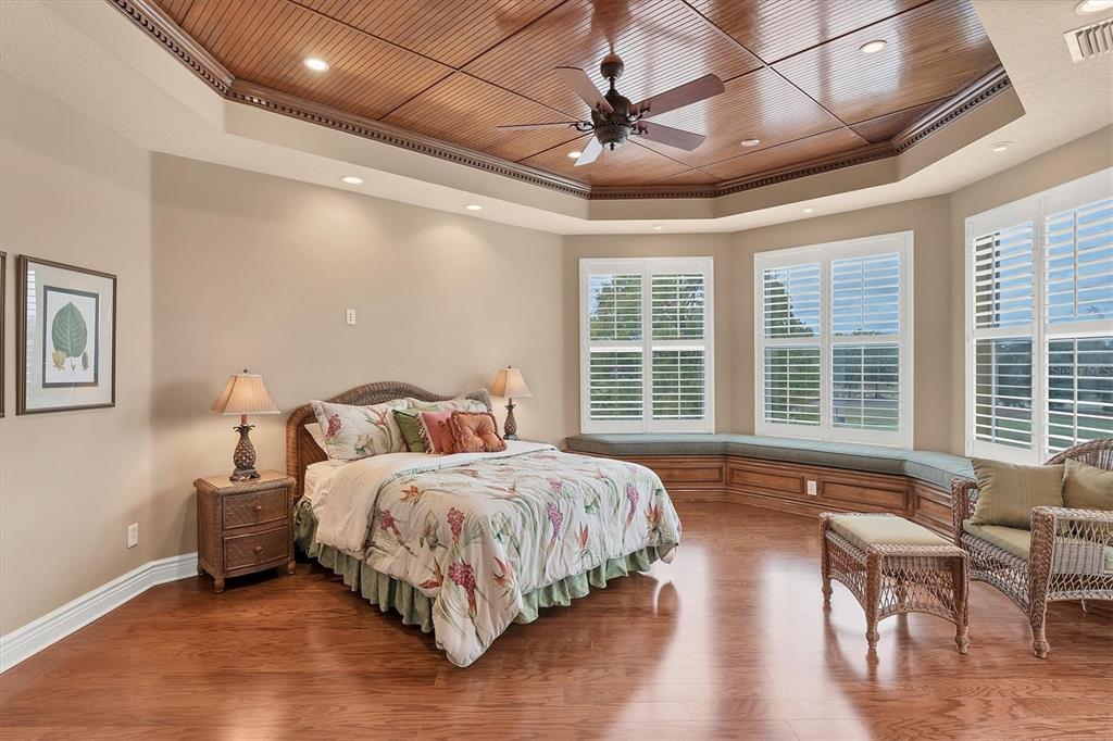 7007 Portmarnock Place Lakewood Ranch, FL 34202 - Photo 56 of 92 a spacious bedroom with a bed and a table