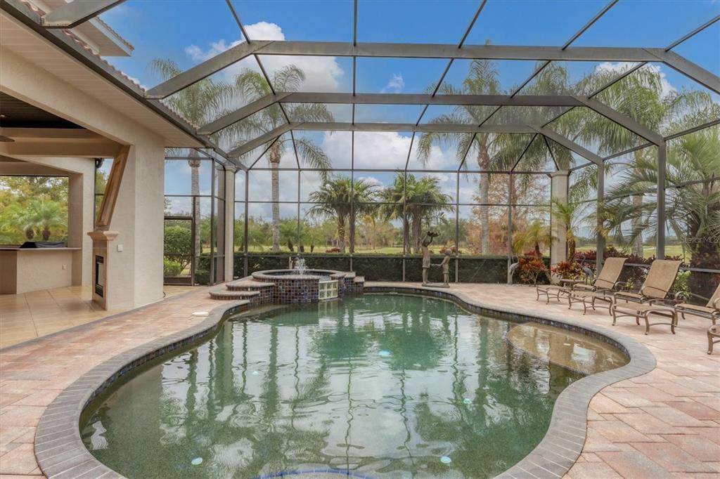 7007 Portmarnock Place Lakewood Ranch, FL 34202 - Photo 62 of 92 a swimming pool with view of lake and mountain view