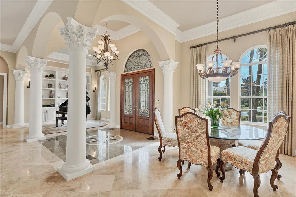 7007 Portmarnock Place Lakewood Ranch, FL 34202 - Photo 9 of 92 a view of a dining room with furniture and chandelier