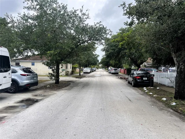 a view of cars parked on a sidewalk