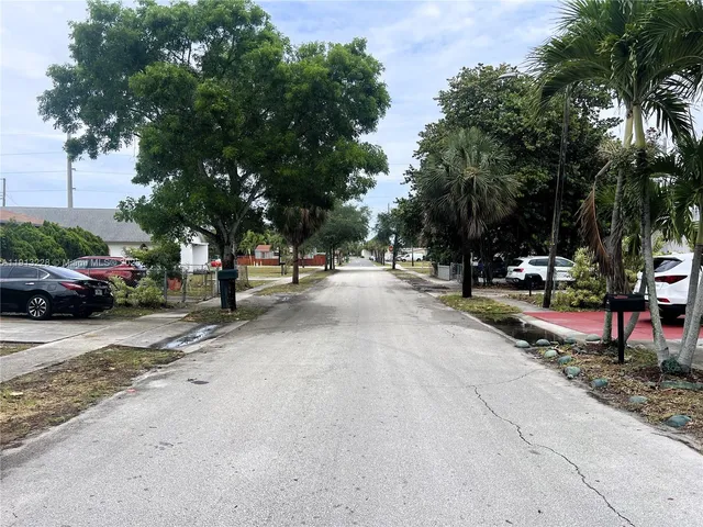 a view of street with parked cars