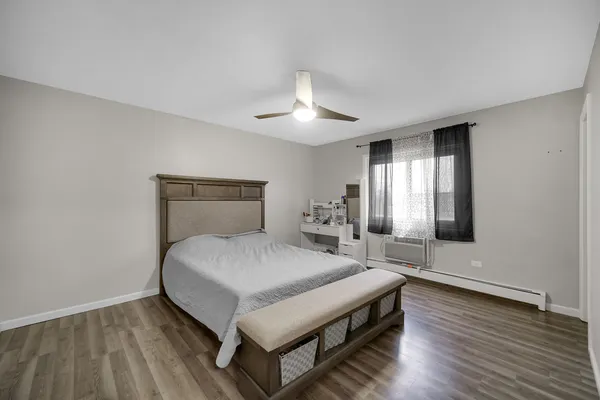 a spacious bedroom with a bed and a chandelier