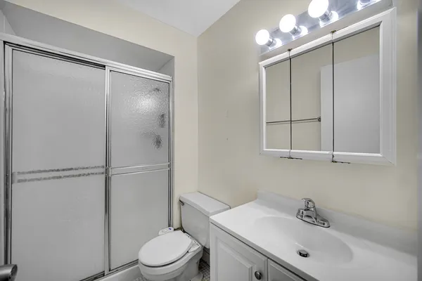 a bathroom with a toilet a sink and a shower