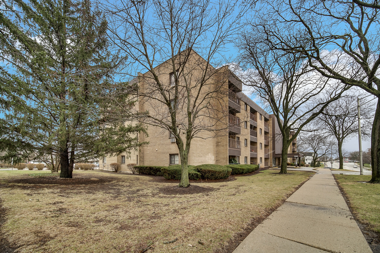 1133 South Finley Road, Unit 310 Lombard, IL 60148 - Photo 2 of 22 a view of road with trees