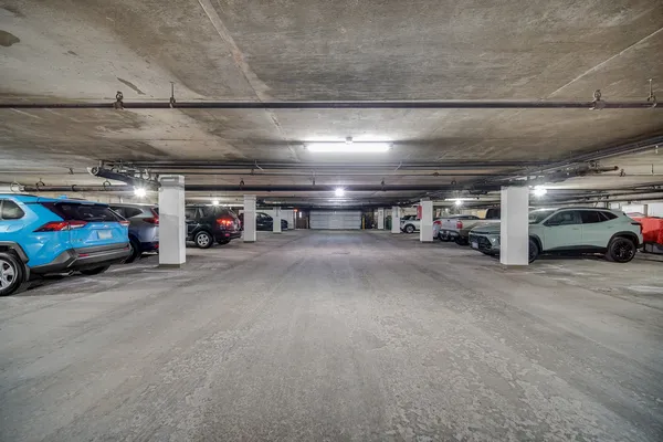 a view of parking garage with cars