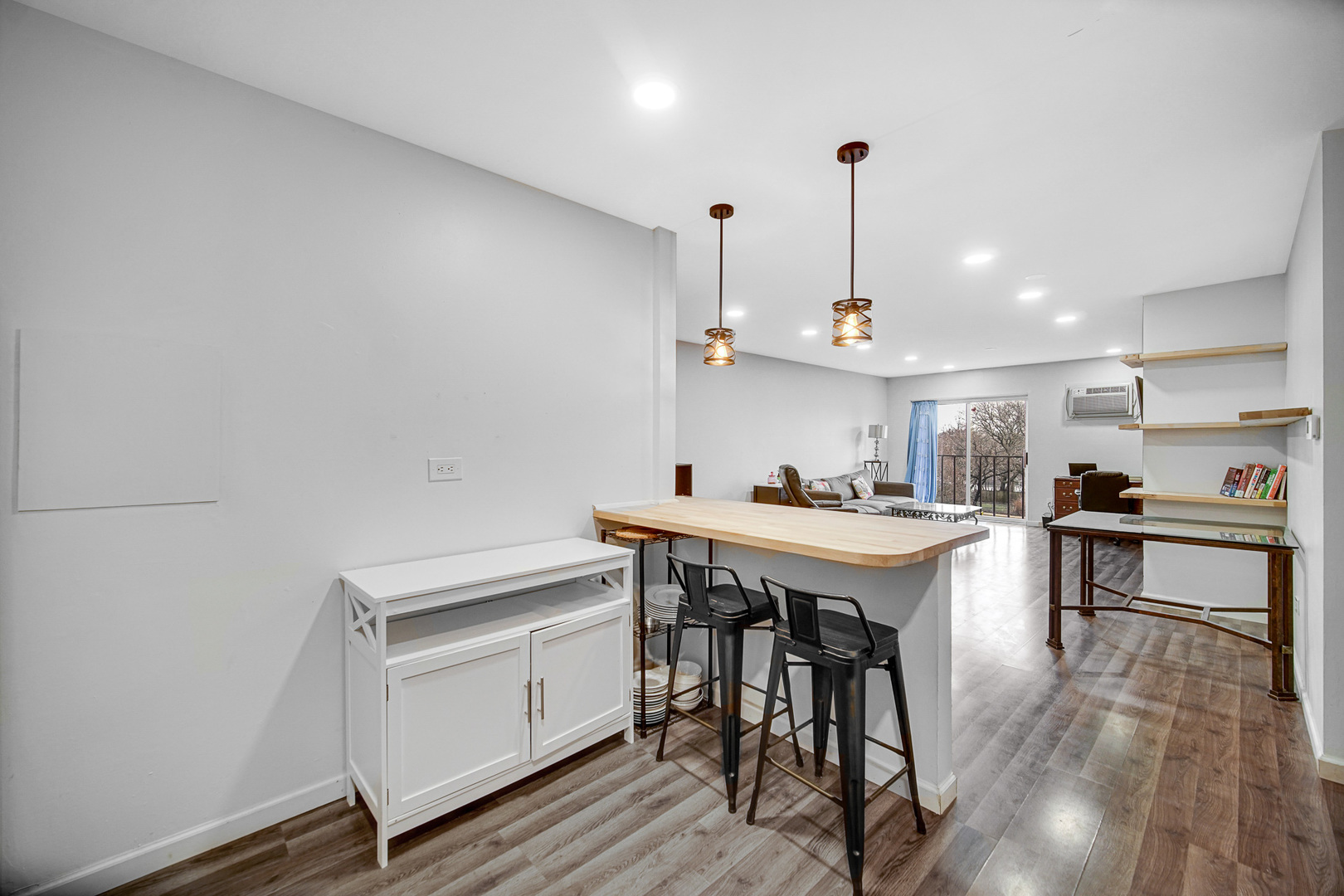 1133 South Finley Road, Unit 310 Lombard, IL 60148 - Photo 5 of 22 a kitchen with stainless steel appliances kitchen island hardwood floor sink and stove