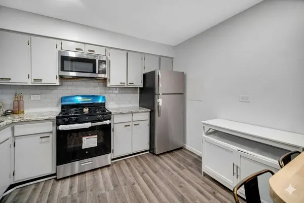 a kitchen with a stove and a microwave