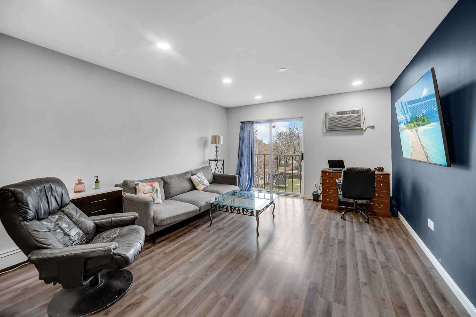 1133 South Finley Road, Unit 310 Lombard, IL 60148 - Photo 8 of 22 a living room with furniture and a flat screen tv