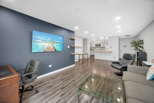 a living room with furniture and a wooden floor
