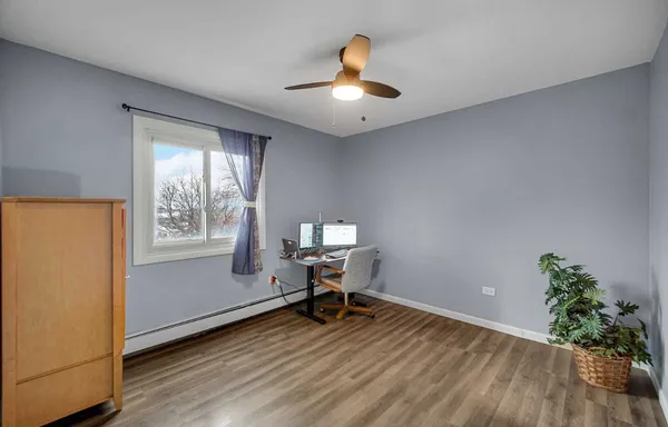 a workspace with furniture window and wooden floor