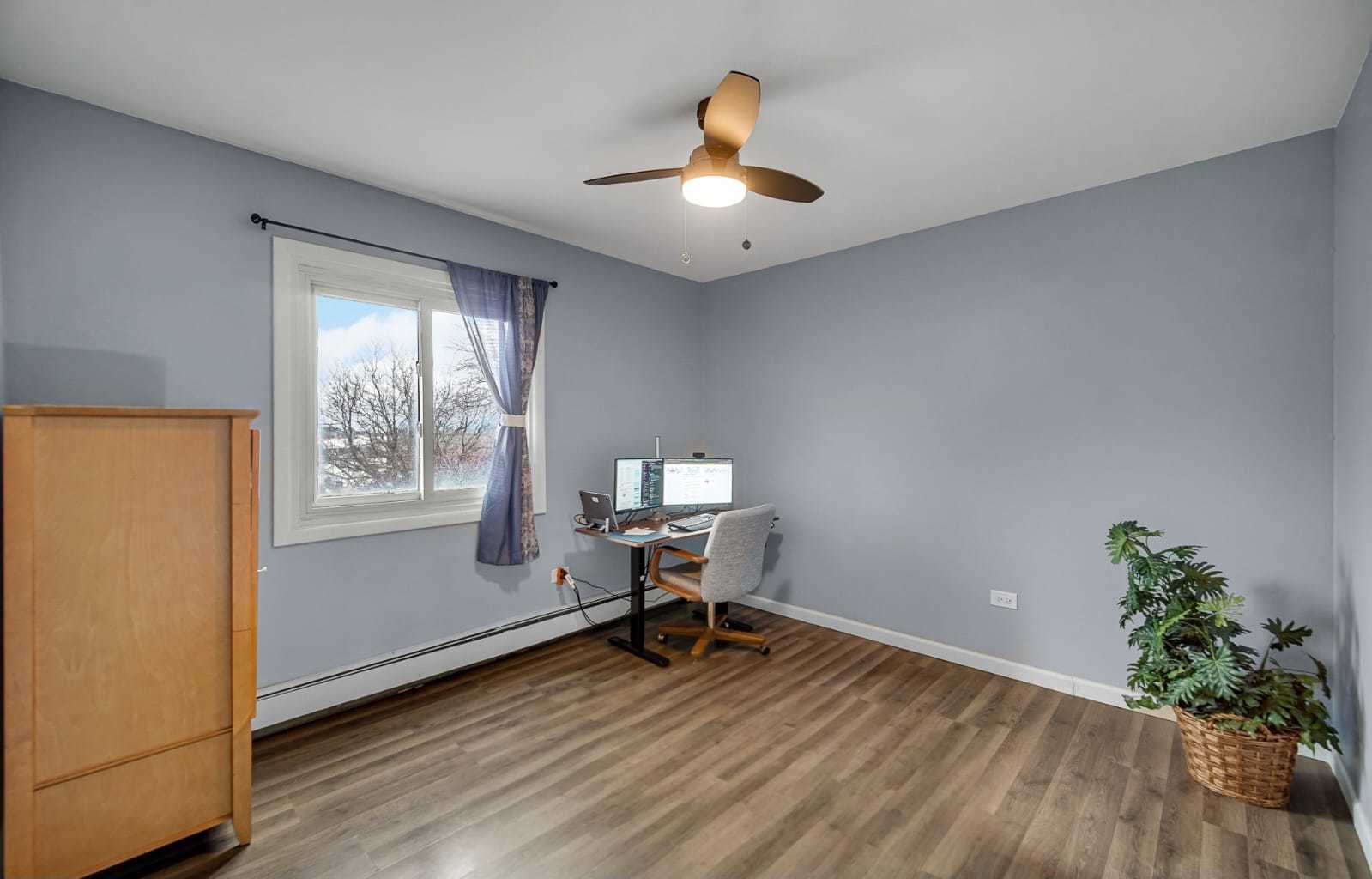 1133 South Finley Road, Unit 310 Lombard, IL 60148 - Photo 10 of 22 a workspace with furniture window and wooden floor