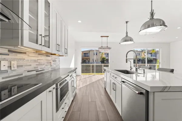 a kitchen with stainless steel appliances a sink stove and cabinets