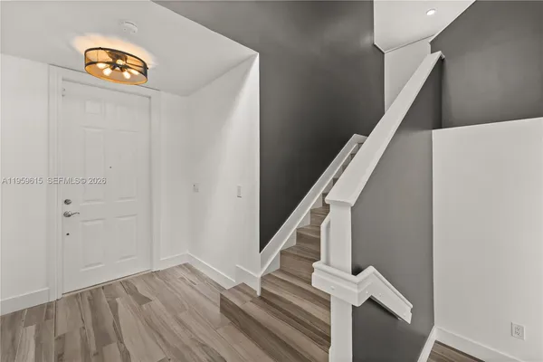 a view of entryway with wooden floor and stairs