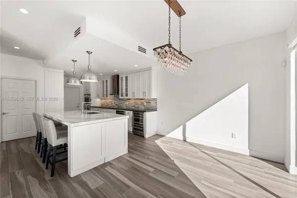 a kitchen with a sink a counter top space and stainless steel appliances