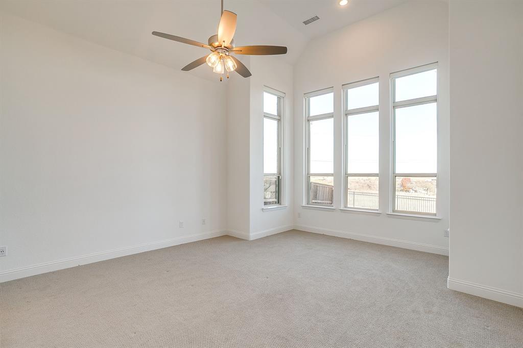 14328 Capridge Road Fort Worth, TX 76008 - Photo 11 of 39 an empty room with chandelier fan and windows