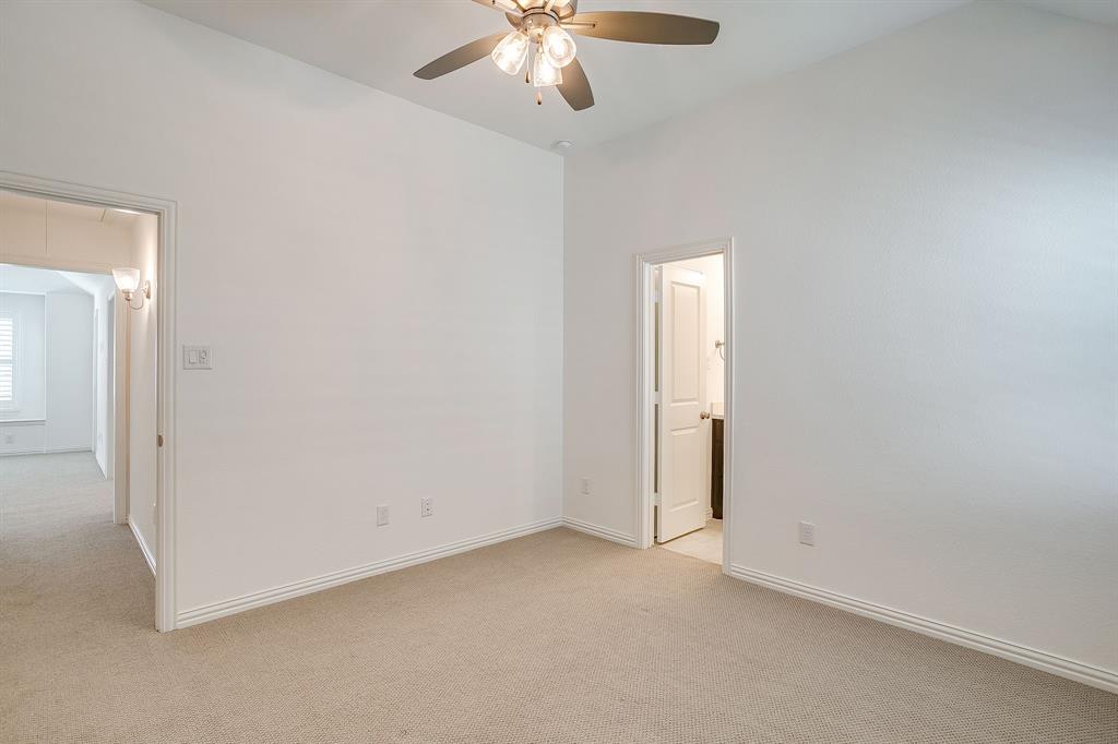 14328 Capridge Road Fort Worth, TX 76008 - Photo 21 of 39 an empty room with a chandelier fan and windows