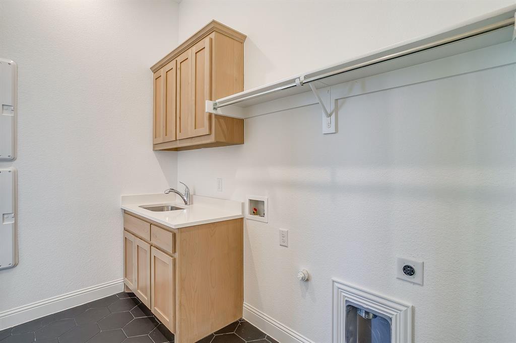 14328 Capridge Road Fort Worth, TX 76008 - Photo 27 of 39 a bathroom with a sink a mirror and cabinets